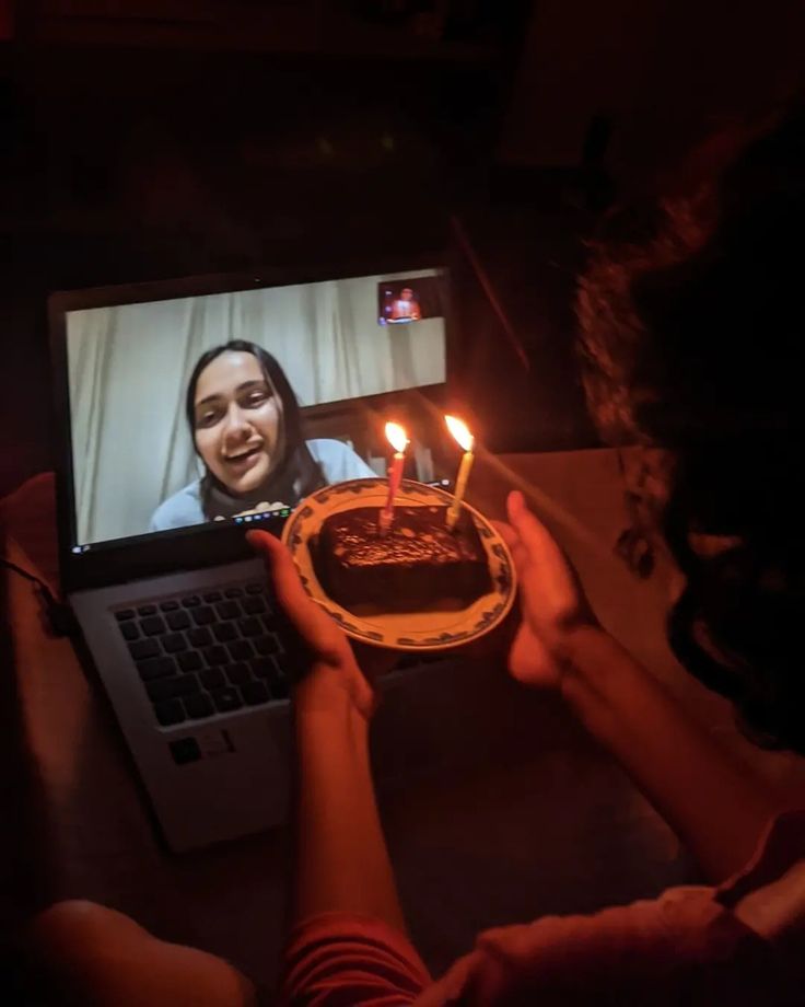 Long-distance birthday with cake and candles on a video call