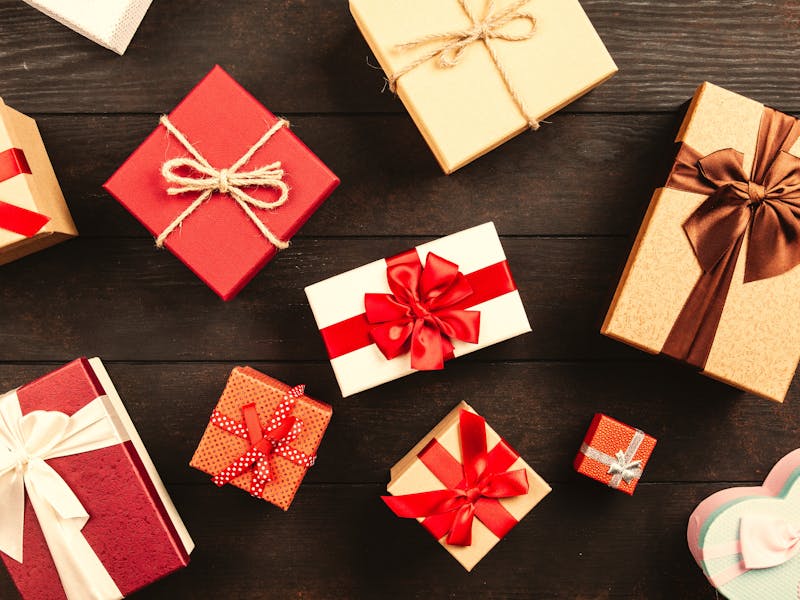 Hands giving a wrapped surprise gift to someone