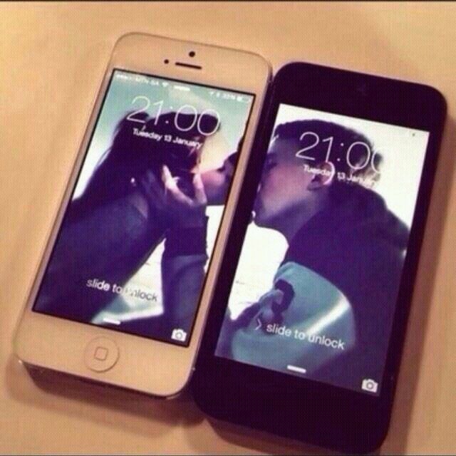 Two phones with matching split-screen couple wallpaper when placed together
